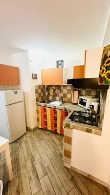 a kitchen with a sink and a refrigerator at Camerini di Santa Cecilia in Palermo