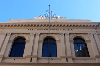 a building with a statue on top of it at Camerini di Santa Cecilia in Palermo