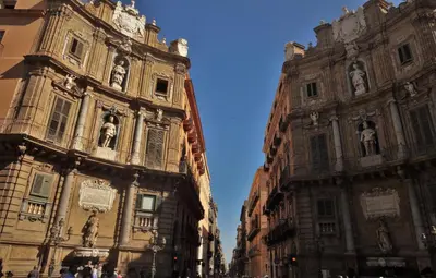 two tall buildings next to each other on a street at I Vicini della Cattedrale in Palermo