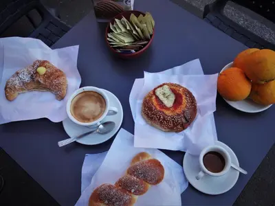 a table topped with plates of pastries and cups of coffee at I Vicini della Cattedrale in Palermo