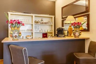 a counter with two vases with flowers on it at BB 22 Charming Rooms & Apartments in Palermo