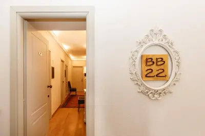 a mirror on a wall with a sign on it at BB 22 Charming Rooms & Apartments in Palermo