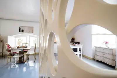a living room with a large white wall with a sculpture at BB 22 Charming Rooms & Apartments in Palermo