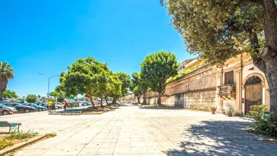a street in a city with trees and buildings at Amazing Sea View in Historic Building in Downtown by Wonderful Italy in Palermo