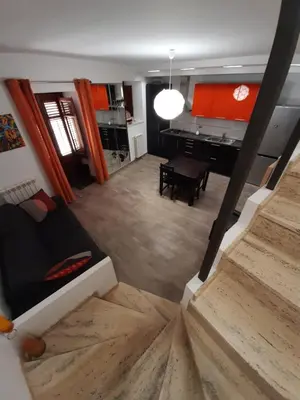 a living room with a couch and a piano at Casa degli Artisti San Lorenzo in Mezzojuso
