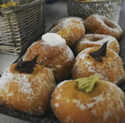a bunch of donuts with powdered sugar on them at Ad Hoc Rooms in Palermo