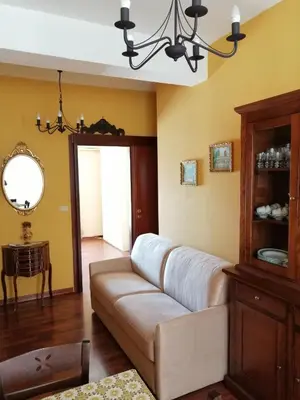 a living room with a couch and a chandelier at Oreto Bridge in Palermo