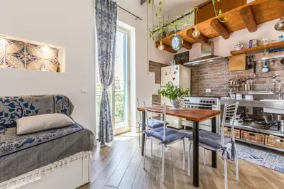 a kitchen and dining room with a table and chairs at Gò Gò House 2 Casa Aprile in Palermo