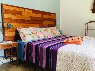 a bedroom with a bed with a wooden head board at Gò Gò House 2 Casa Aprile in Palermo