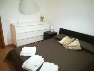 a bedroom with a bed with towels on it at Villa Mimmo in Lascari