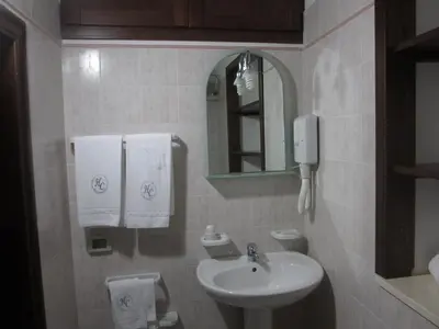 a bathroom with a sink and a mirror at Hotel Columbia in Palermo