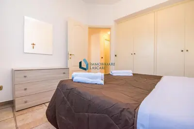 a bedroom with a large bed with two pillows on it at Villa Nettuno con piscina privata in Campofelice di Roccella