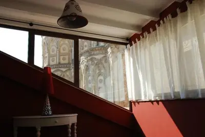 a room with a window and a table and a lamp at Locanda Re Ruggero in Monreale