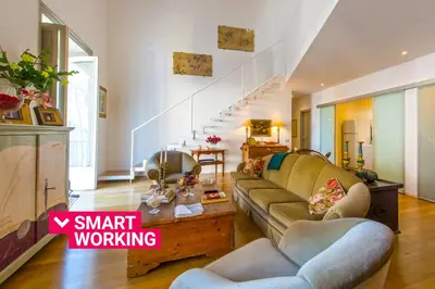 a living room with a couch and a staircase at Charming Apartment in the City Center by Wonderful Italy in Palermo