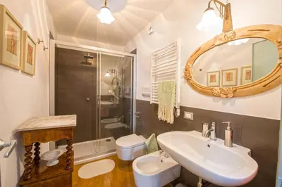 a bathroom with a sink and a toilet and a mirror at Charming Apartment in the City Center by Wonderful Italy in Palermo