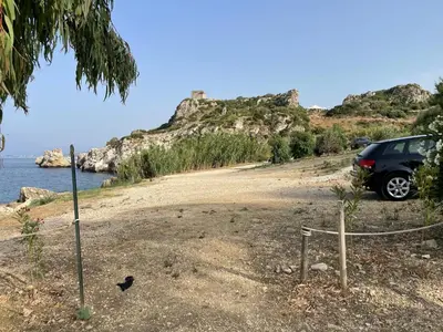 a car parked on the side of a beach at Villa Hibiscus Scopello in Scopello