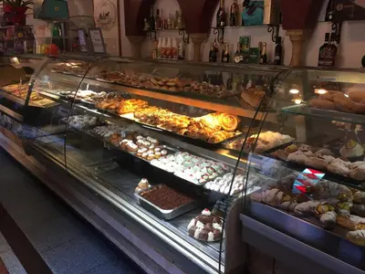 a bakery display case filled with lots of pastries at Kala Rooms in Palermo