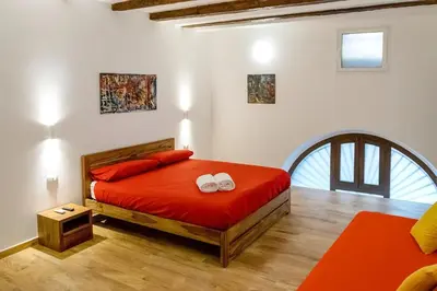 a bedroom with a bed with two towels on it at Kala Rooms in Palermo
