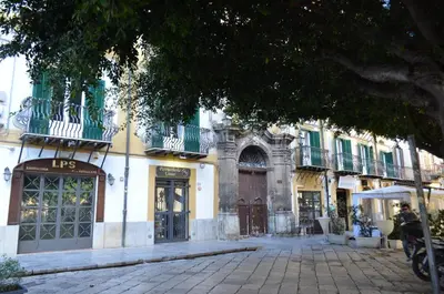 a building with a street in front of it at Kala Rooms in Palermo