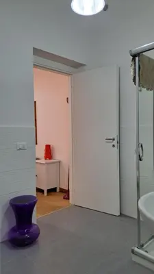 a bathroom with a purple vase in a room at Affittacamere Garibaldi in Alcamo
