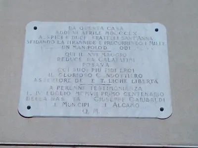 a room with two tables and chairs and a brick wall at Affittacamere Garibaldi in Alcamo