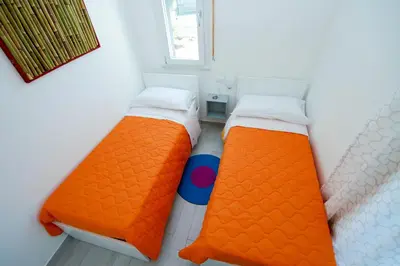 two twin beds in a room with a window at Villa Barbara...a 100 passi dal mare!!!! in Lascari