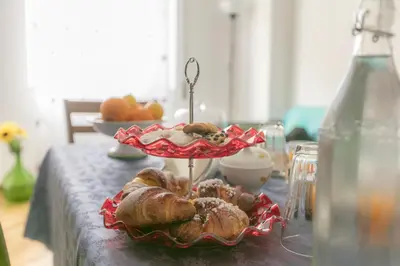 a table with a plate of pastries on a table at Ai Bastioni del Massimo in Palermo