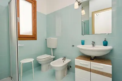 a bathroom with a toilet and a sink at Riva Sea Apartments in Castellammare del Golfo