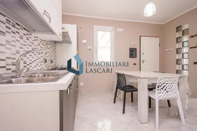 a kitchen with a sink and a table at Villa Ricky, a pochi passi dal mare in Lascari