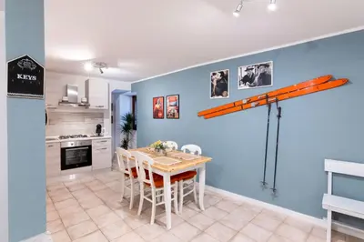 a kitchen with a table and a ladder on the wall at Arianna's House Historical Market in Palermo