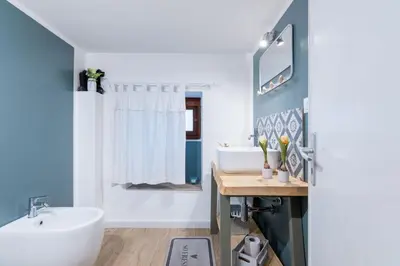 a bathroom with a white tub and a sink at Arianna's House Historical Market in Palermo