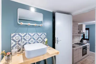 a bathroom with a white sink and a blue wall at Arianna's House Historical Market in Palermo