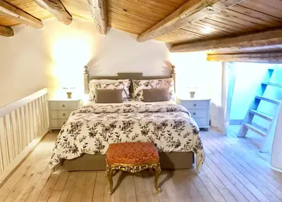 a bedroom with a large bed and a wooden floor at Casa Vigliena in Palermo