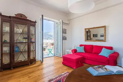 a living room with a red couch and a table at Luxury Apartment * Immo's House* in Palermo