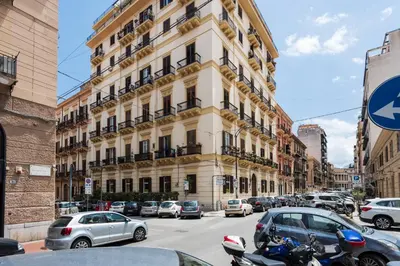 a tall building with cars parked in front of it at Luxury Apartment * Immo's House* in Palermo