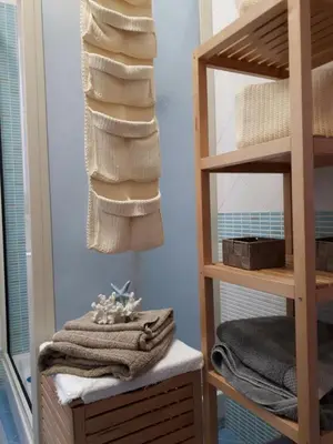 a bathroom with a stack of towels and a mirror at Blu Terrace in San Vito lo Capo