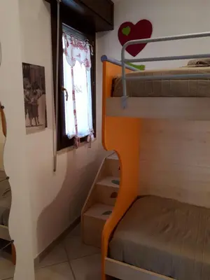 a bedroom with two bunk beds and a window at Blu Terrace in San Vito lo Capo