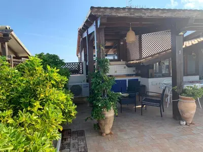 an outdoor patio with plants and a table and chairs at Blu Terrace in San Vito lo Capo