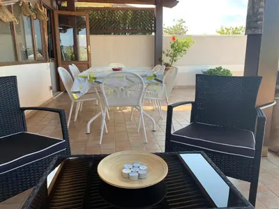 a patio with a table and chairs on a patio at Blu Terrace in San Vito lo Capo