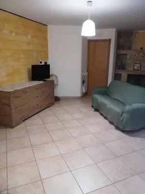 a living room with a bed and a tiled floor at Villa Aurora Per Vacanze in Palermo
