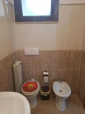 a bathroom with a toilet and a sink at Villa Aurora Per Vacanze in Palermo