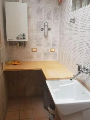 a bathroom with a white sink and a counter at Villa Aurora Per Vacanze in Palermo