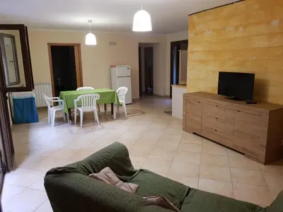 a person laying on a couch in a living room at Villa Aurora Per Vacanze in Palermo