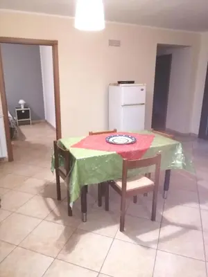 a kitchen with a table with a green table cloth on it at Villa Aurora Per Vacanze in Palermo