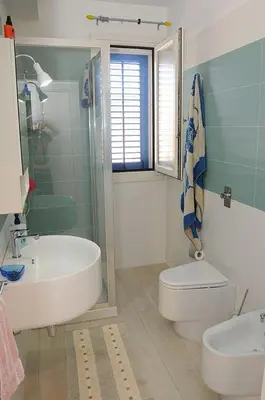 a bathroom with a tub and a toilet and a sink at Appartamento Irma Dario in San Vito lo Capo