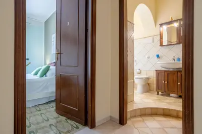 a bathroom with a toilet and a sink at Villa Salvatore in Capaci