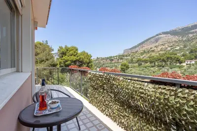 a bottle of wine sitting on a table on a balcony at Villa Salvatore in Capaci