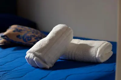 a rolled up towel on top of a bed at Elisir Suite Rooms by Marino Tourist in San Vito lo Capo