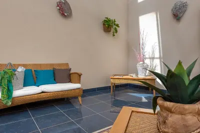 a living room with a couch and a table at Helios Hotel in San Vito lo Capo
