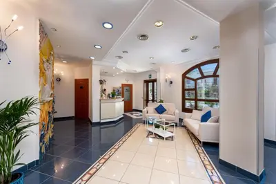 a living room with a couch and a table at Helios Hotel in San Vito lo Capo
